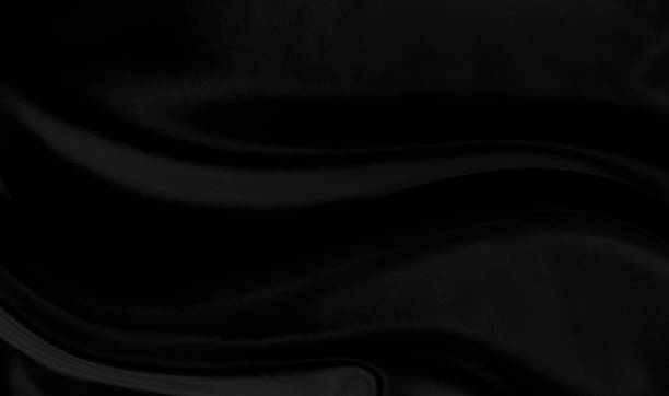 istock Black gray satin dark fabric texture luxurious shiny that is abstract silk cloth background with patterns soft waves blur beautiful. 1348779266