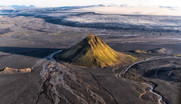 Maelifell is a volcano located in southern Highlands of Iceland.  It is a composite cone volcano formed by volcanic eruptions underneath the Myrdlsjokull glacier which can be seen above the volcano cone.