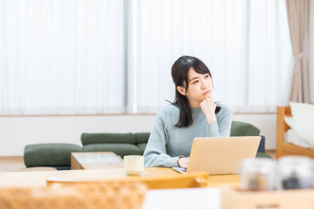 young asian woman using laptop,think, Beautiful young asian woman using laptop,think, worried stock pictures, royalty-free photos & images