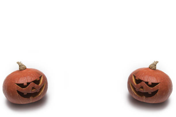 Silhouette in red tones of a carved halloween pumpkin. Dark mode Halloween 2020