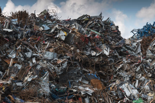 istock piled up iron scrap on scrap yard against sky 1348815231