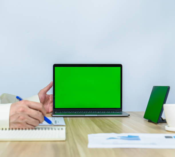 istock close up green screen on laptop with working environment and copy space 1348818482