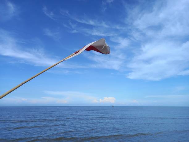 istock Indonesian flag flying on the beach pier 1348820412