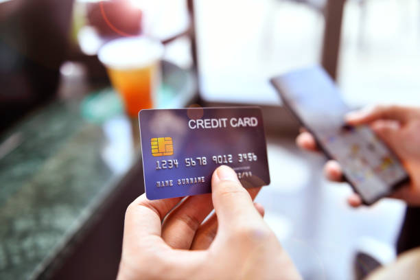 istock Hands holding a credit card and using smart phone for online shopping 1348823459