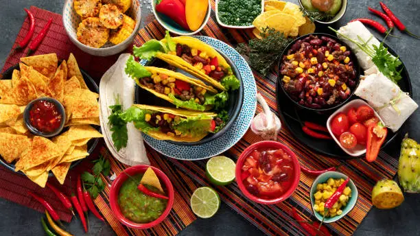 Photo of Mexican food, many dishes of the mexican cuisine on dark background