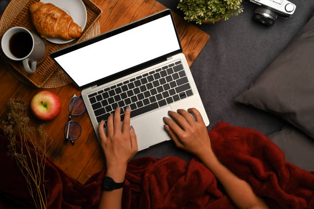 istock Young woman using laptop computer on gray carpet. 1348828509