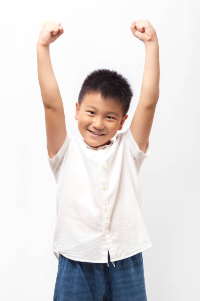 istock Heathy happy kid putting hands up, strong pose 1348830594
