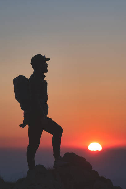 istock Man on top of a mountain at sunset 1348830887