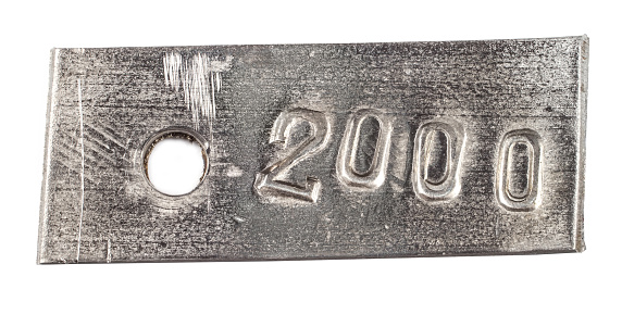 Metal tag with number 2000. Steel number on a white background.