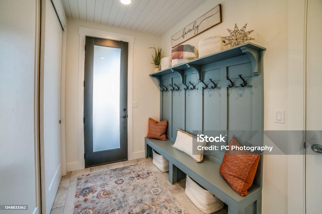 Simple yet elegant bench in the mudroom Beautifully staged space in new home Mudroom Stock Photo