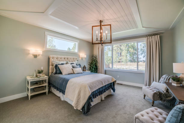 istock Coffered ceiling in bedroom with chandelier hanging above the bed 1348833368