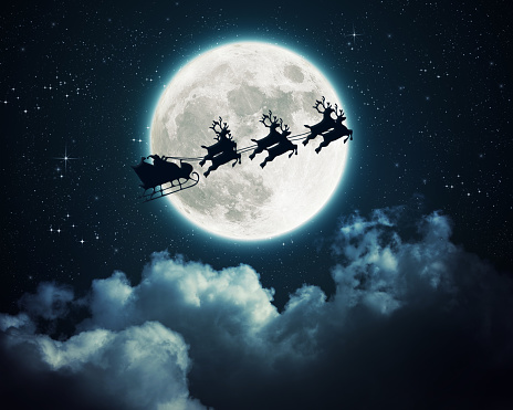 Santa Claus in a sleigh flying over the moon in the night