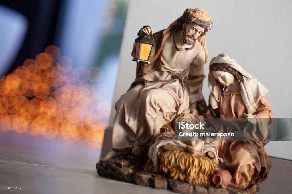 Christmas nativity. Old figurines for the nativity scene. Old Christmas nativity set, with Joseph, Mary, and the baby Christ child in a manger. Christmas tree on the background. Nativity Scene Stock Photo