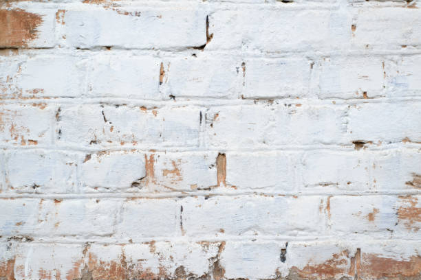 istock Brick wall with spot of white paint, copy space for text. Textured background of horizontal brickwork, close-up 1348836697