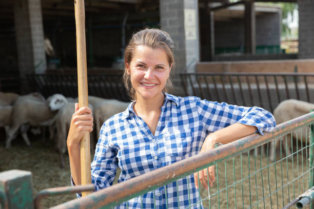 istock Successful woman farmer in enclosure with sheeps 1348837701