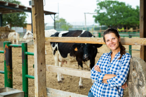 istock Female farmer posing in cowshed at dairy farm 1348837724