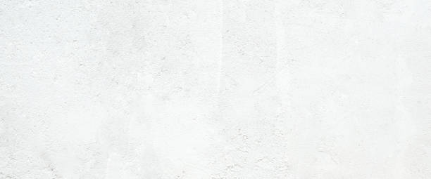 istock White concrete stone surface paint wall background, Grunge cement paint texture backdrop, White rough concrete stone wall background, Copy space for interior design background, banner, wallpaper 1348837794