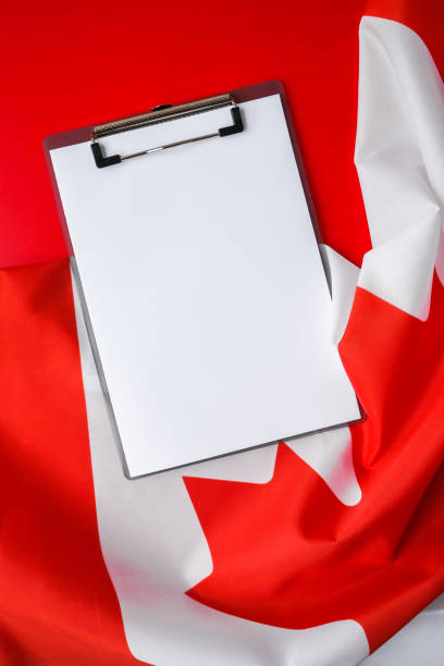 istock The National Flag of Canada. Canadian Flag or the Maple Leaf with empty paper note Copy space. Tourist traveler or patriotism. International relations concept. Independence day 1348842090