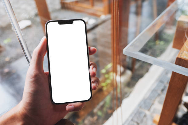 istock a man holding mobile phone with blank white screen in cafe 1348844719