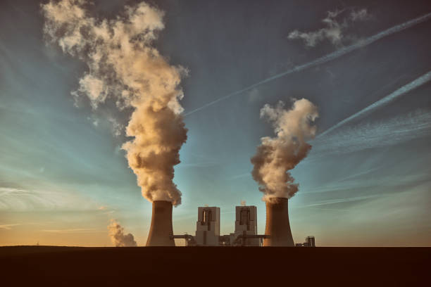 Toned photograph of a coal fired power plant with pollution Toned high resolution photograph of a modern brown-coal burning power plant with pollution. ozone layer photos stock pictures, royalty-free photos & images