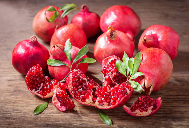 istock fresh ripe pomegranates with leaves 1348848683