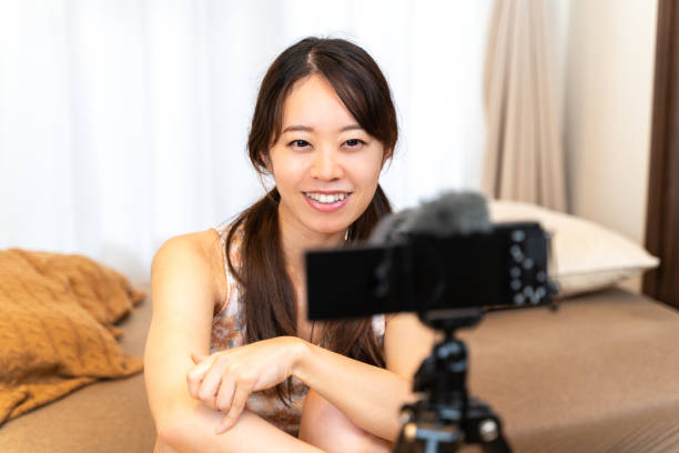 istock Young woman shooting a video 1348850199