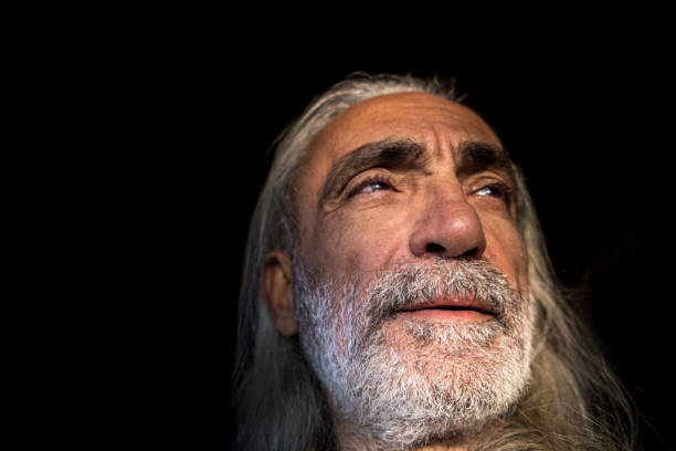 istock Old man black background portrait 1348850434
