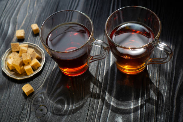 istock Two cups with black tea and brown sugar 1348851804