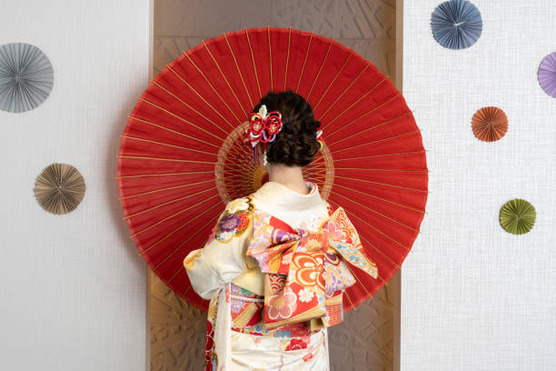 Female adult in kimono with an umbrella spread I took a picture before the coming-of-age ceremony kimono photos stock pictures, royalty-free photos & images