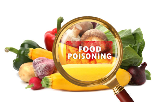 istock Magnifying glass and vegetables on white background. Food poisoning concept 1348854579