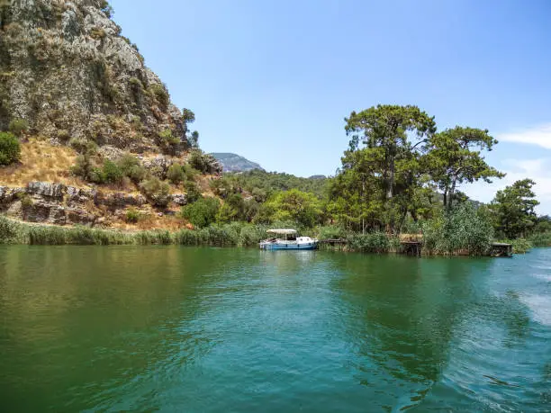 Green water in Dalyan river, Turkey - view of the coastal mountains