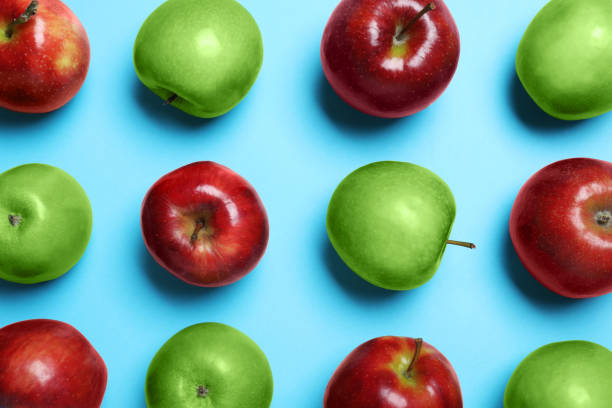istock Tasty ripe apples on light blue background, flat lay 1348855143