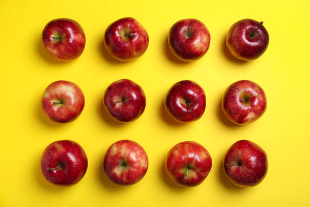 istock Tasty red apples on yellow background, flat lay 1348855144
