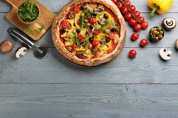 istock Flat lay composition with vegetable pizza on light grey wooden table. Space for text 1348855408