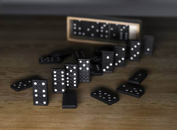 istock Domino game pieces on wood table with wooden box case 1348856267