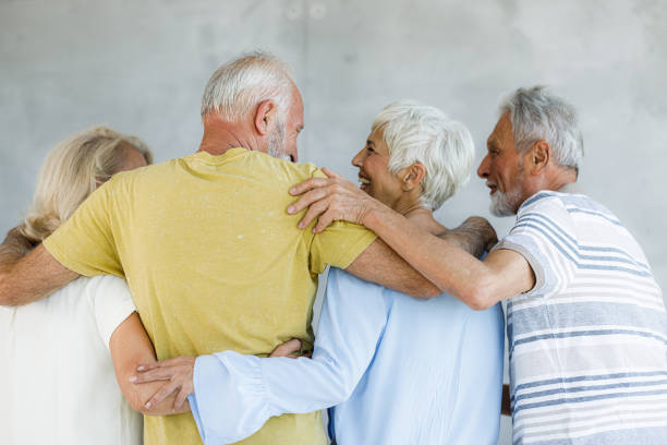 istock Back view of happy senior couples embracing and talking. 1348856919