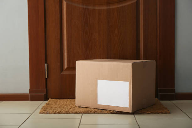 istock Parcel on rug near door. Delivery service 1348856927