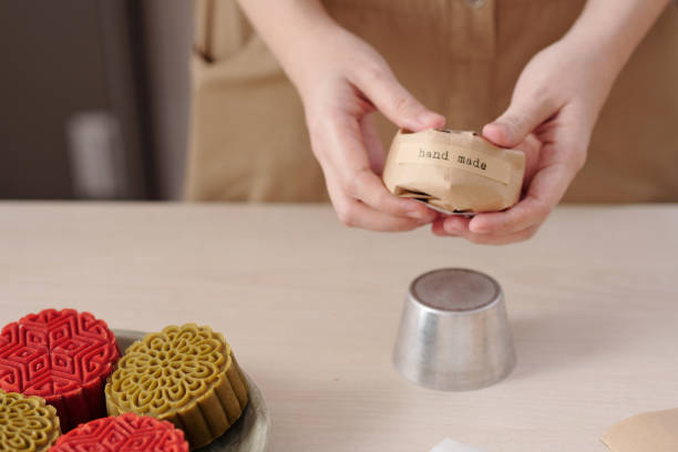 istock Woman Wrapping Homemade Mooncakes 1348858322