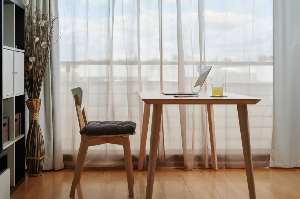 istock Interior of workroom with laptop on table 1348863035