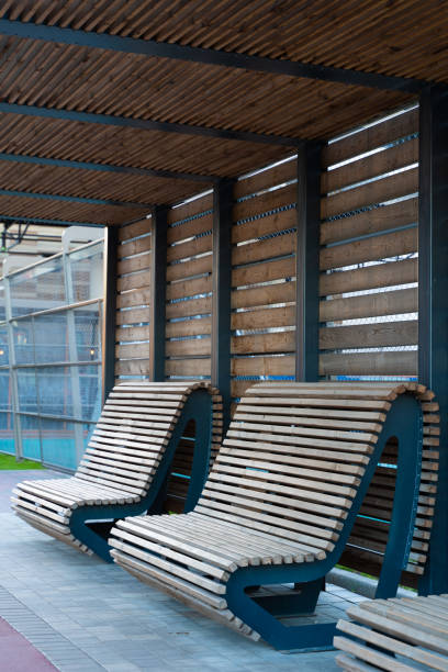 istock two wooden benches for resting under a wooden canopy 1348863309