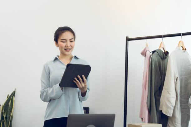 istock Young asian entrepreneurs use a tablet while checking online purchase orders. 1348863427