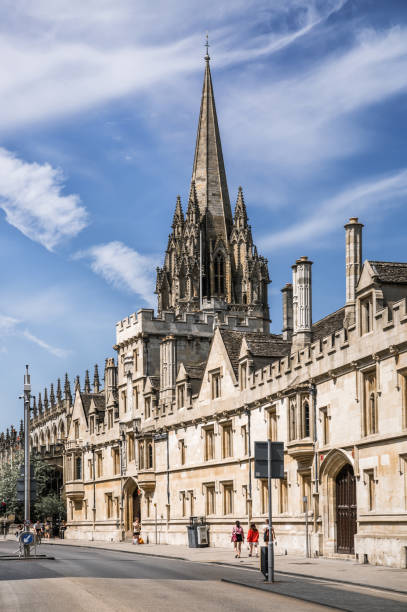 High street view with University Church of St Mary the Virgin tower. Oxford University buil Oxford, UK - June2, 2021: High street view with University Church of St Mary the Virgin tower. Oxford University buil queens college stock pictures, royalty-free photos & images