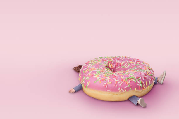 chica con donut. concepto de comida rápida, sobrepeso. fondo rosa mínimo con espacio de copia - diabetes food fotografías e imágenes de stock