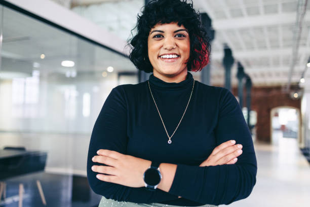 istock Female entrepreneur smiling in a creative office 1348871453