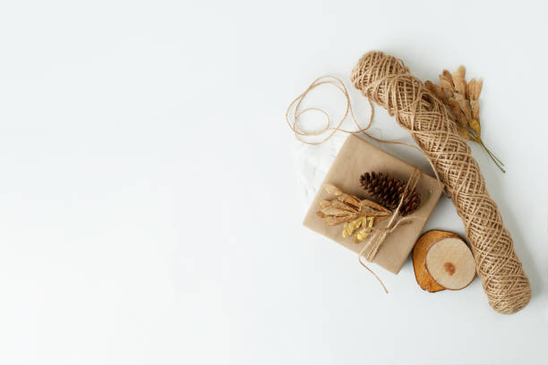 istock Eco-friendly Christmas decor: gift boxes Packed in brown Kraft paper, natural decorations, wreath, pine on white background. Zero Waste holiday packing concept, handmade gifts package, 2022 New year 1348871577