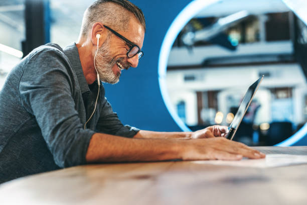 Smiling businessman attending a virtual meeting in an office