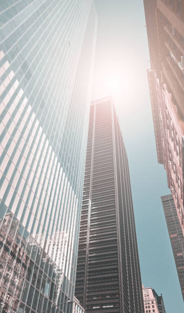 istock Looking up at New York skyscrapers, color toning applied, US. 1348872541