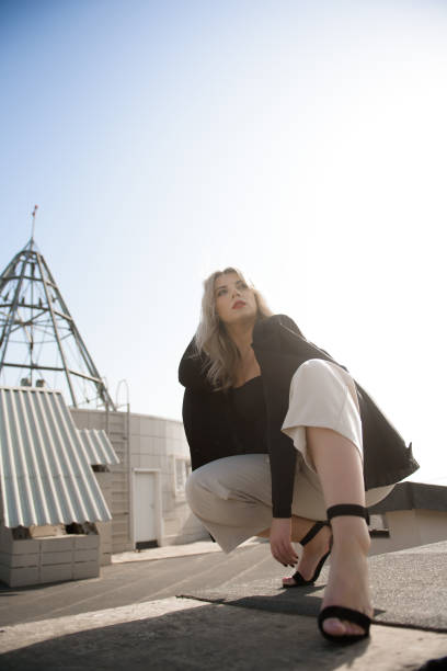 istock Woman standing at rooftop on a sunny autumn day. 1348872707