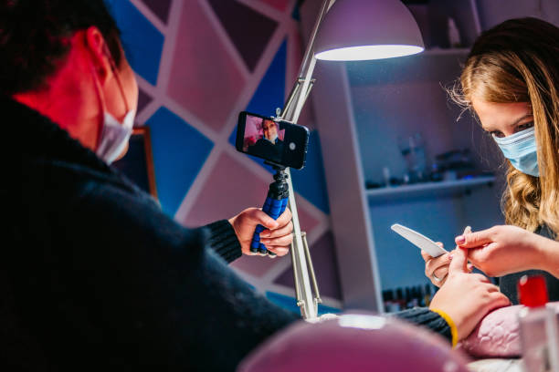 istock Filming process of doing nails in beauty salon for vlog 1348872758