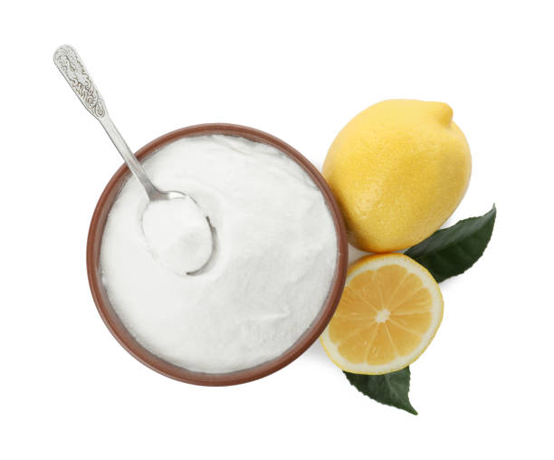 istock Baking soda and cut lemons on white background, top view 1348872827